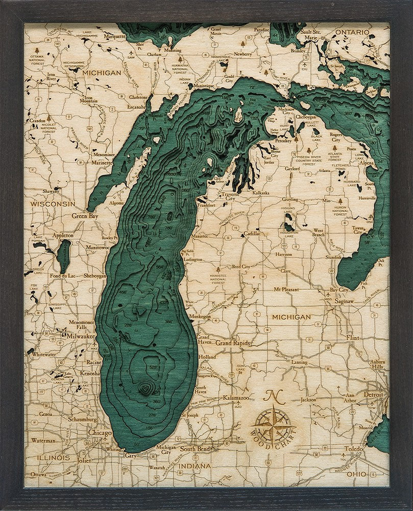 Lake Michigan 3D layered wood map in laser-cut Baltic birch, shown framed against a light wall