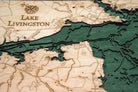 Lake Livingston, Texas 3D layered wood map in laser-cut Baltic birch, shown framed against a light wall