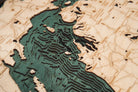 Lake Michigan 3D layered wood map in laser-cut Baltic birch, shown framed against a light wall