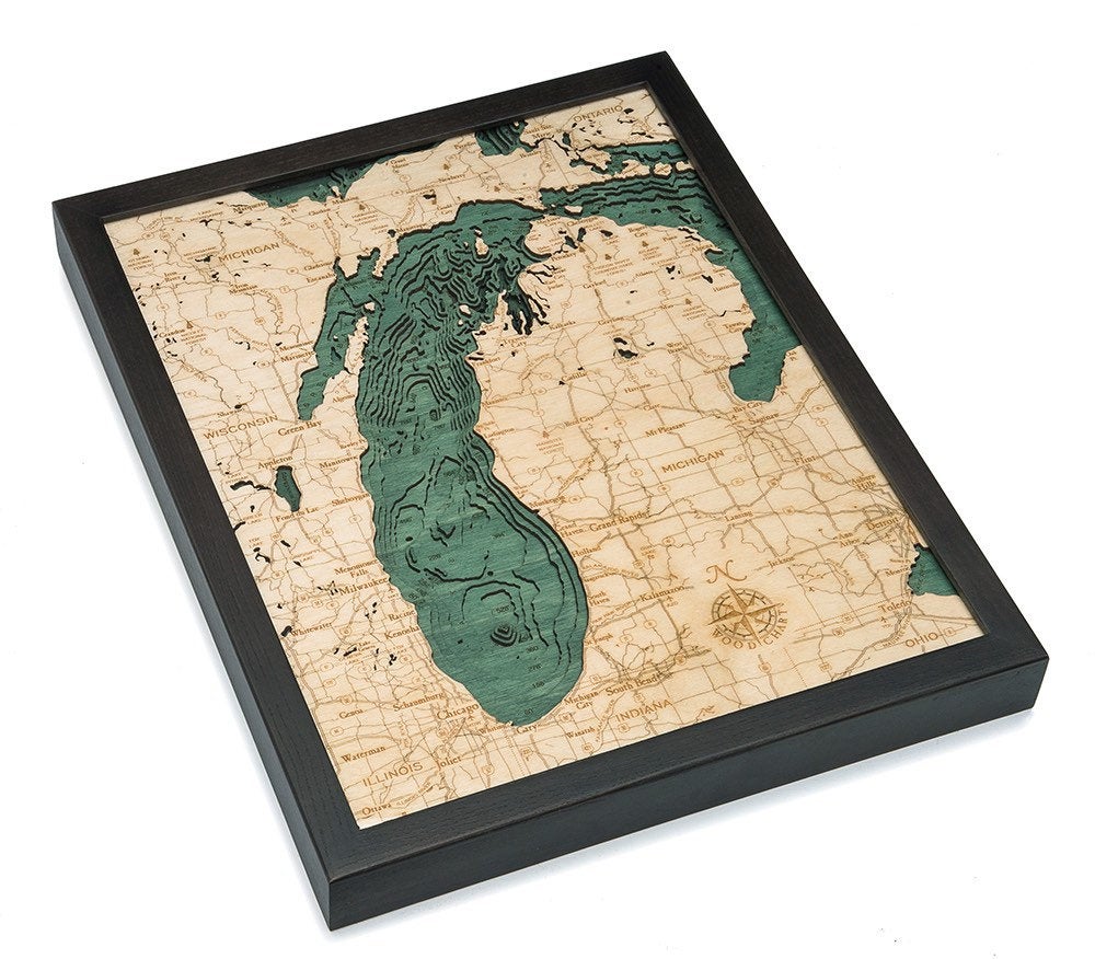 Lake Michigan 3D layered wood map in laser-cut Baltic birch, shown framed against a light wall
