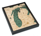 Lake Michigan 3D layered wood map in laser-cut Baltic birch, shown framed against a light wall