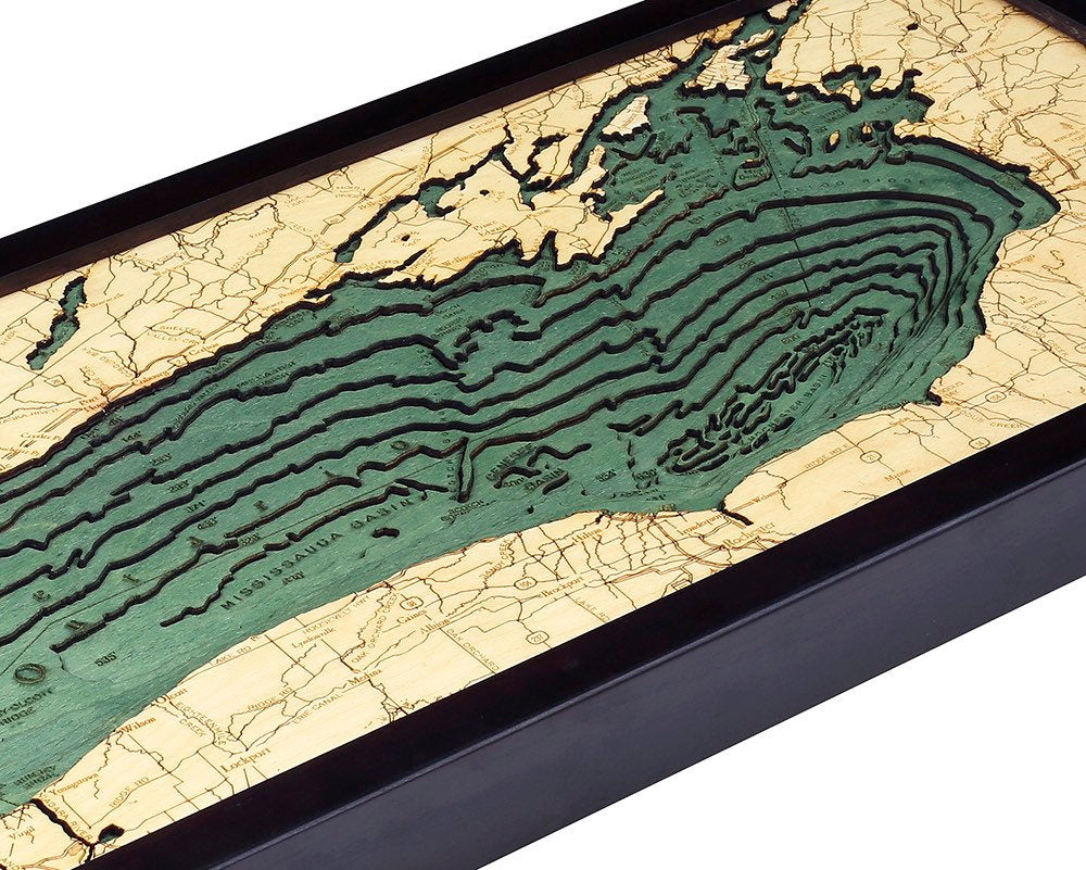 Lake Ontario 3D layered wood map in laser-cut Baltic birch, shown framed against a light wall