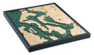 Whidbey & Camano Islands, Washington 3D layered wood map in laser-cut Baltic birch, shown framed against a light wall