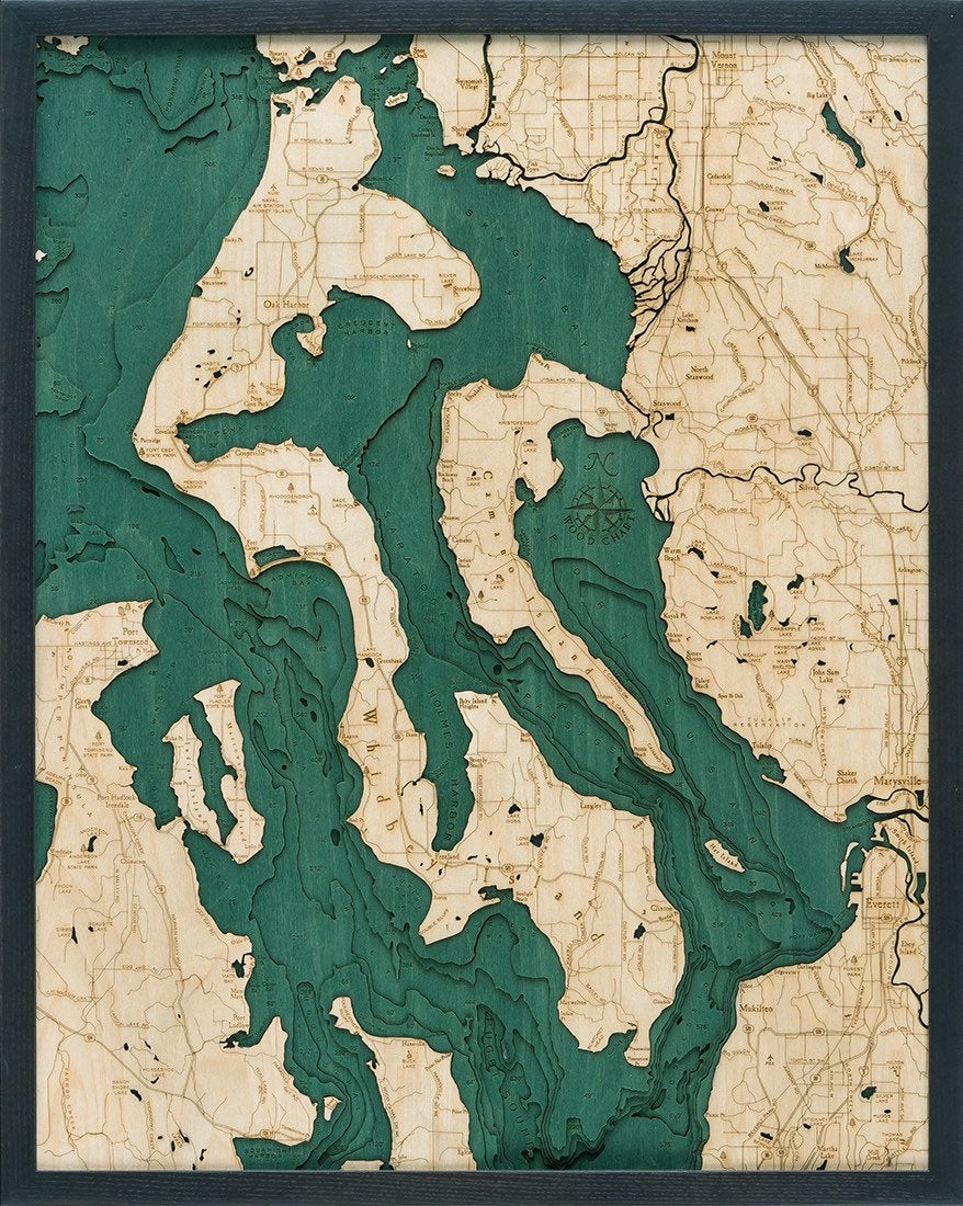 Whidbey & Camano Islands, Washington 3D layered wood map in laser-cut Baltic birch, shown framed against a light wall