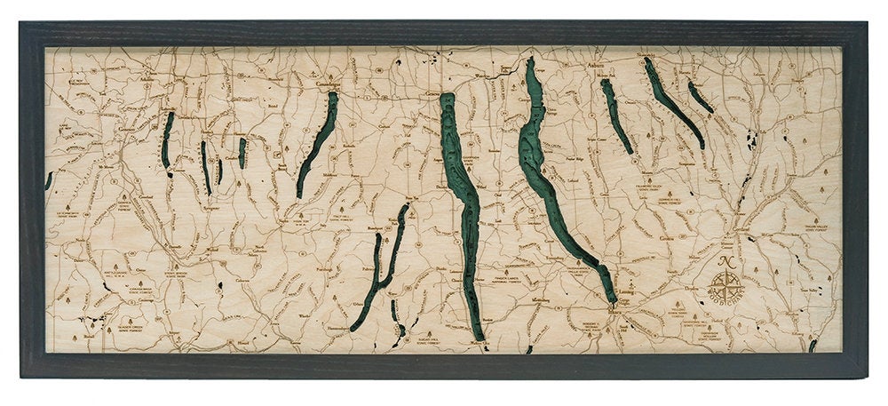 Finger Lakes, New York 3D layered wood map in laser-cut Baltic birch, shown framed against a light wall