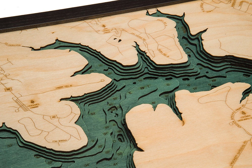 Lake Georgetown, Texas 3D layered wood map in laser-cut Baltic birch, shown framed against a light wall