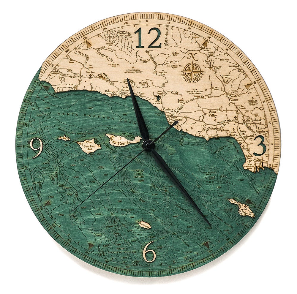Santa Barbara, California wood wall clock in laser-cut Baltic birch, shown framed against a light wall