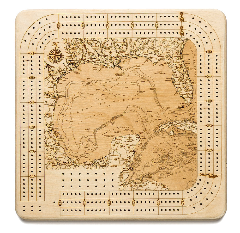 Gulf Of Mexico wood cribbage board in laser-cut Baltic birch, shown framed against a light wall