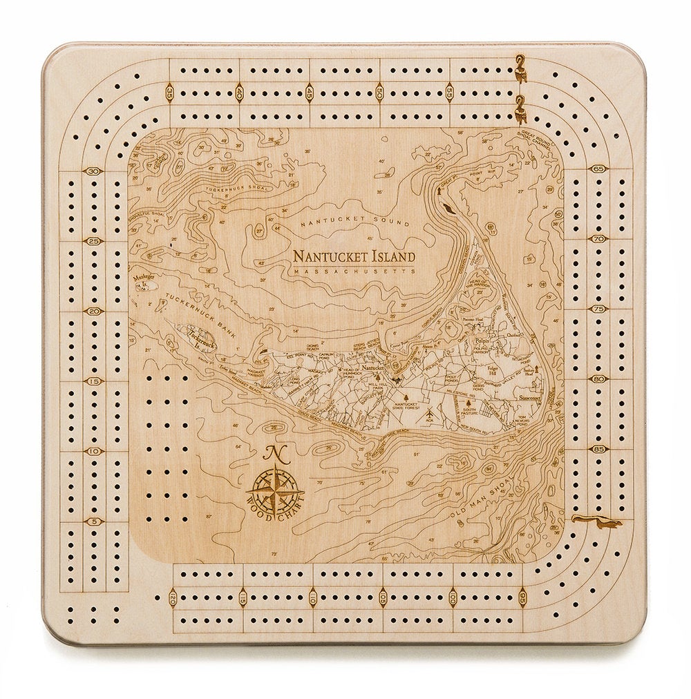 Nantucket, Massachusetts wood cribbage board in laser-cut Baltic birch, shown framed against a light wall