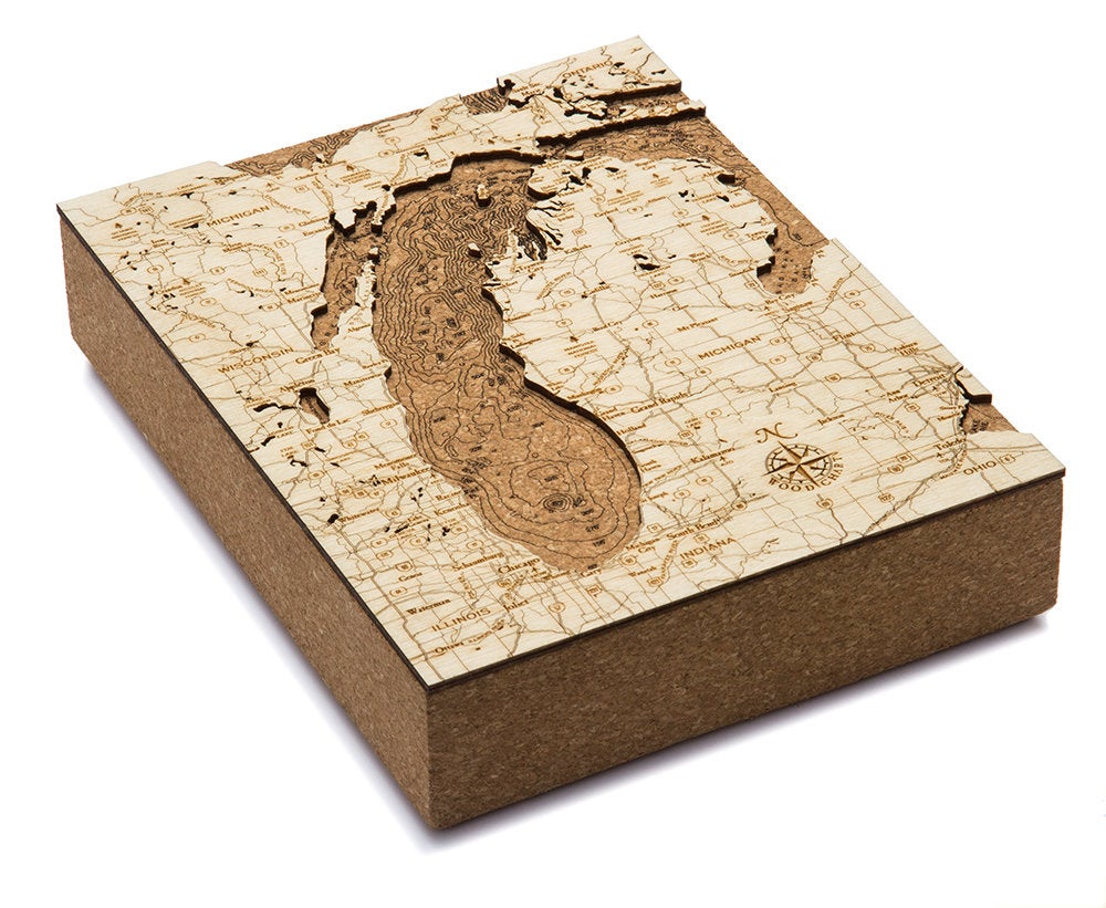 Lake Michigan framed cork map in laser-cut Baltic birch, shown framed against a light wall