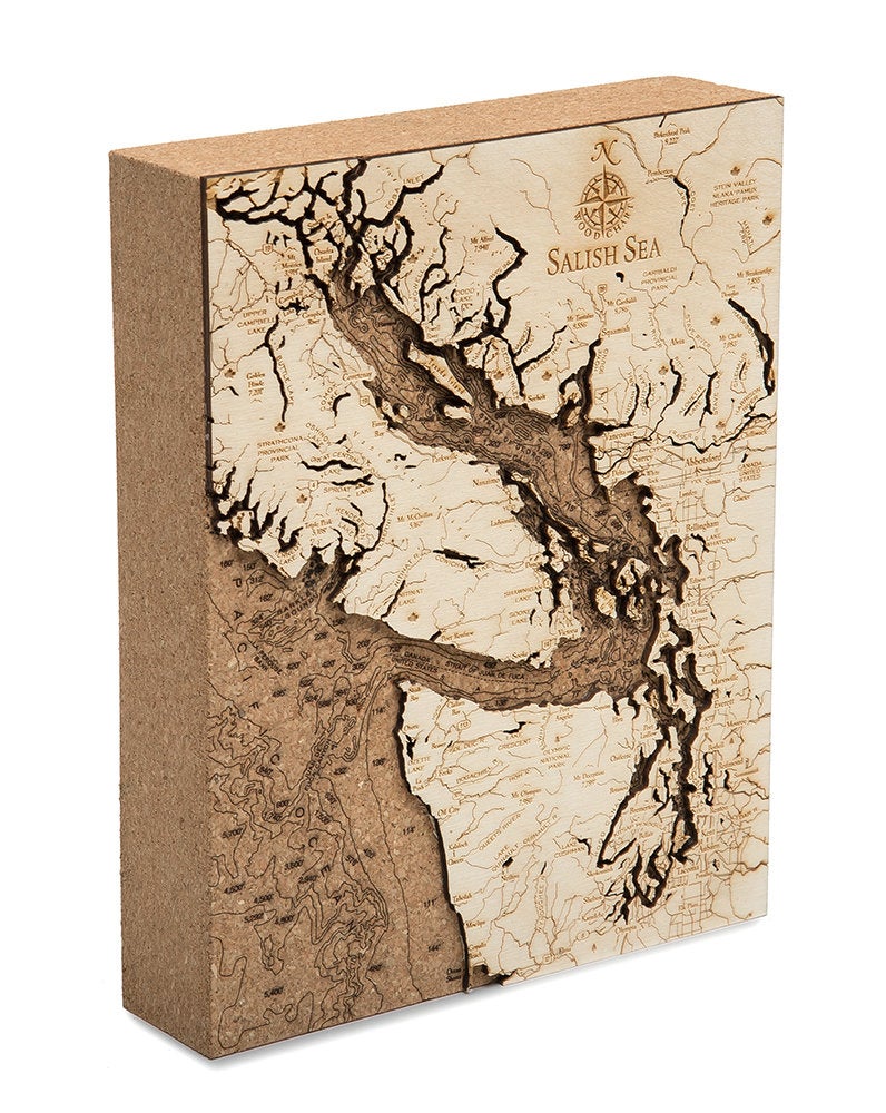 Salish Sea, Washington framed cork map in laser-cut Baltic birch, shown framed against a light wall