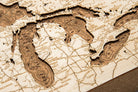 Great Lakes framed cork map in laser-cut Baltic birch, shown framed against a light wall
