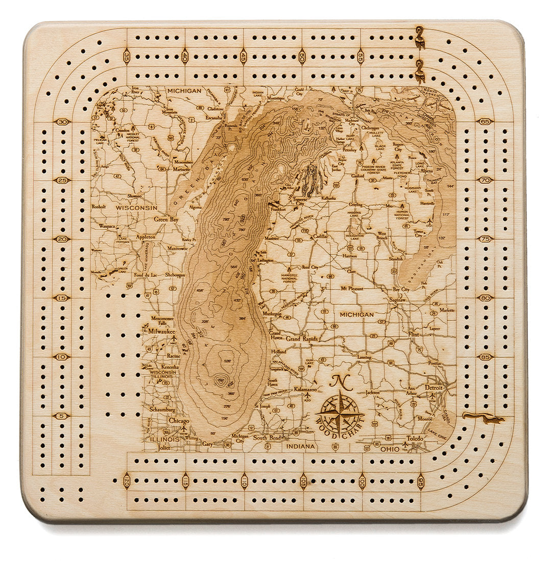 Lake Michigan wood cribbage board in laser-cut Baltic birch, shown framed against a light wall