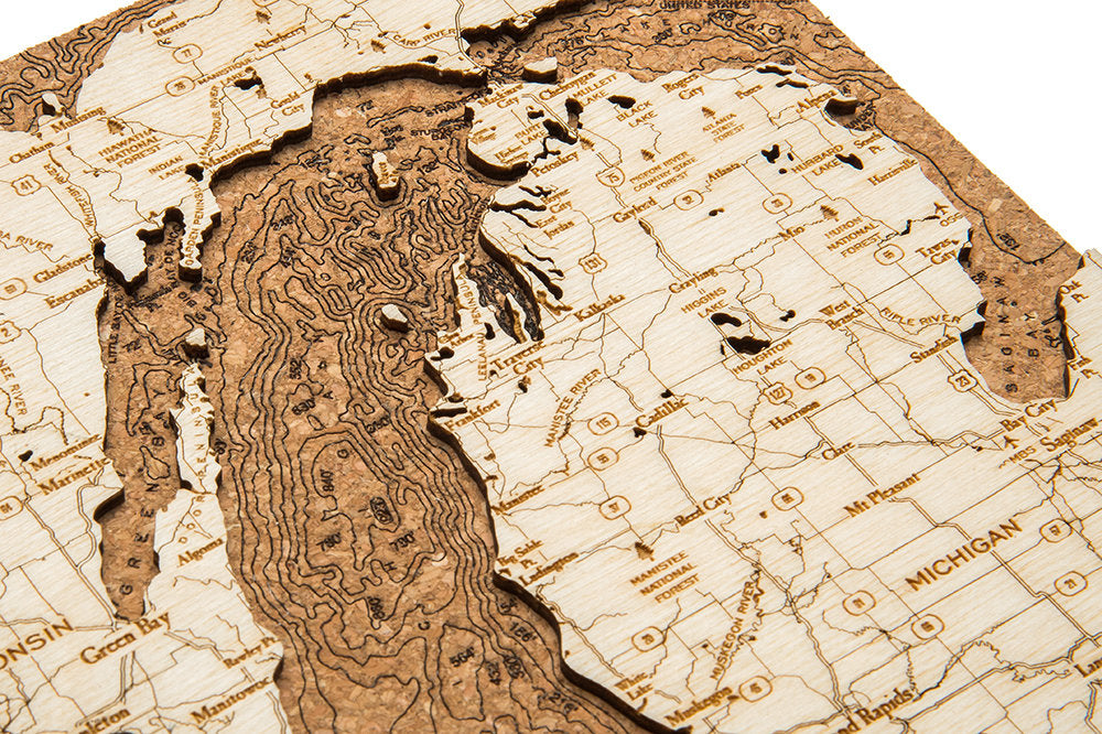Lake Michigan framed cork map in laser-cut Baltic birch, shown framed against a light wall