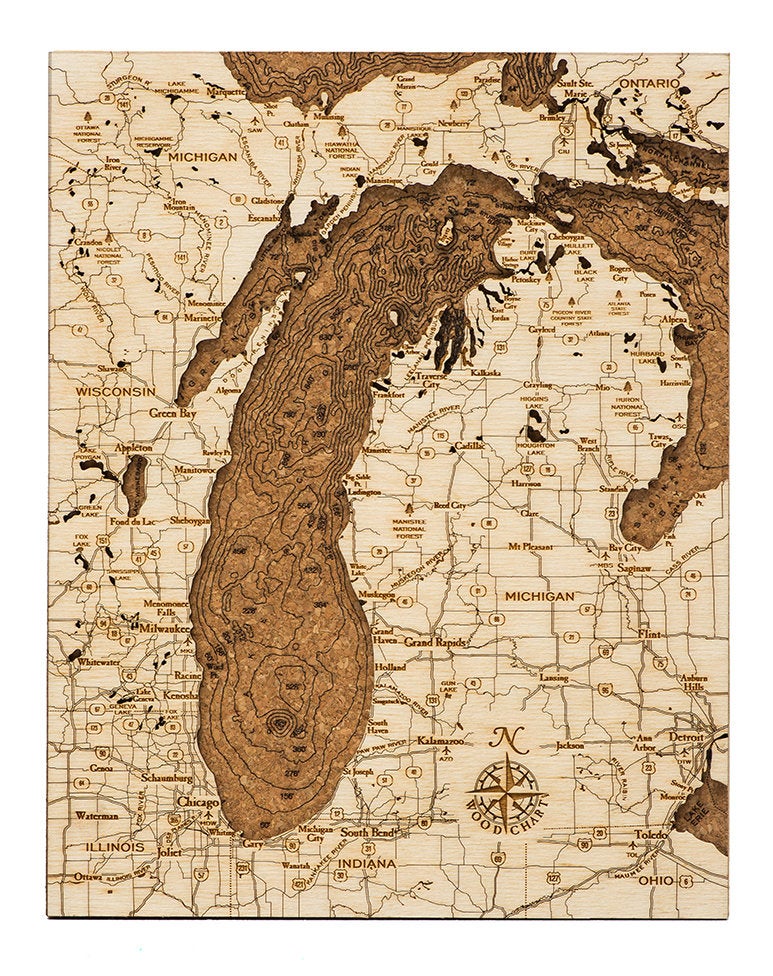 Lake Michigan framed cork map in laser-cut Baltic birch, shown framed against a light wall