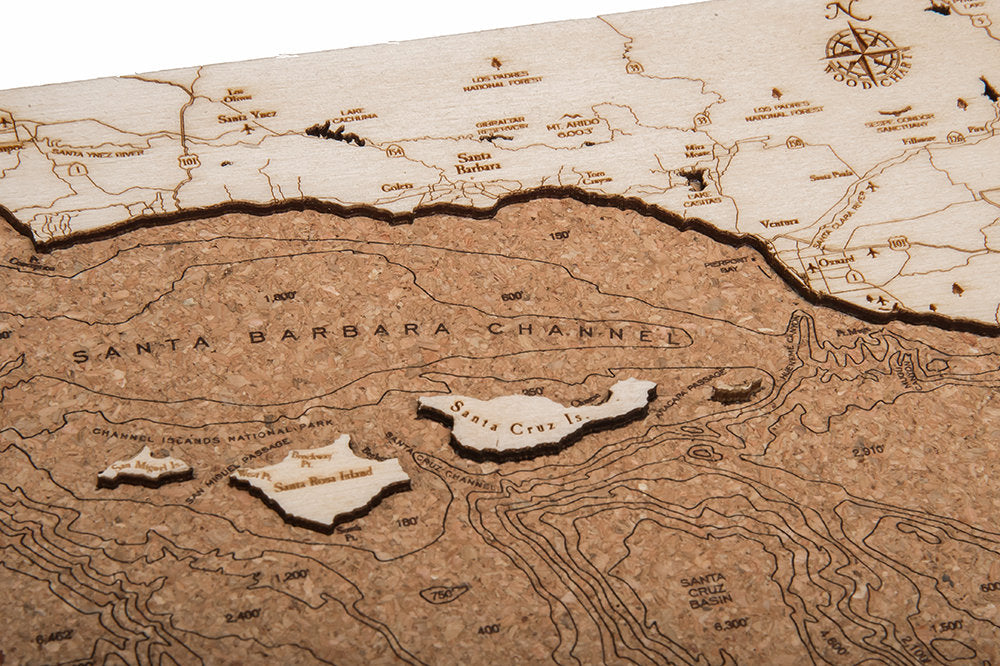 Santa Barbara, California framed cork map in laser-cut Baltic birch, shown framed against a light wall