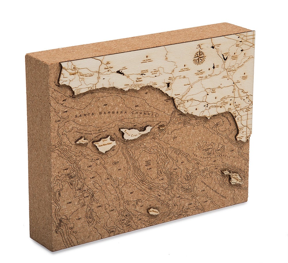 Santa Barbara, California framed cork map in laser-cut Baltic birch, shown framed against a light wall