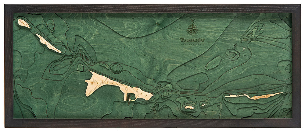 Walker Cay, Bahamas 3D layered wood map in laser-cut Baltic birch, shown framed against a light wall