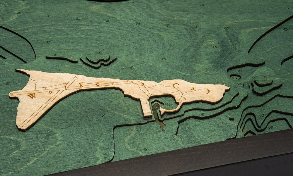 Walker Cay, Bahamas 3D layered wood map in laser-cut Baltic birch, shown framed against a light wall