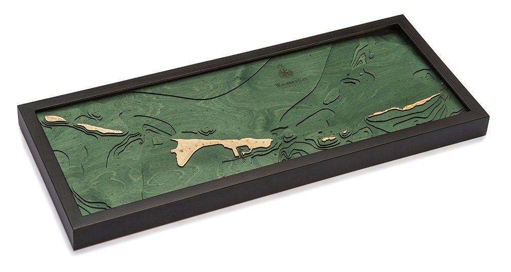 Walker Cay, Bahamas 3D layered wood map in laser-cut Baltic birch, shown framed against a light wall