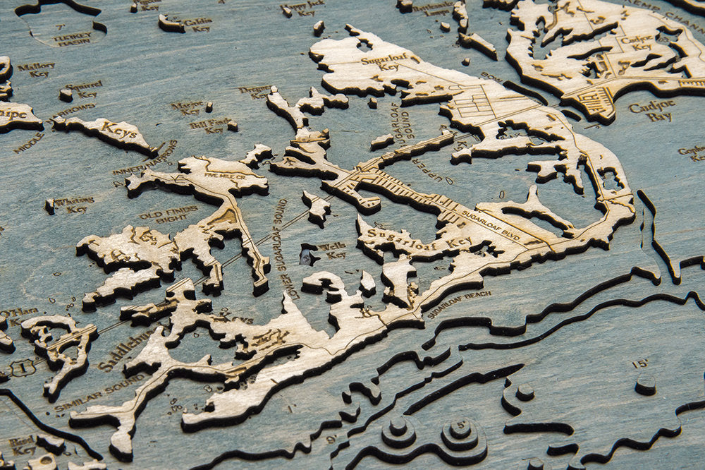Florida Keys 3D layered wood map in laser-cut Baltic birch, shown framed against a light wall