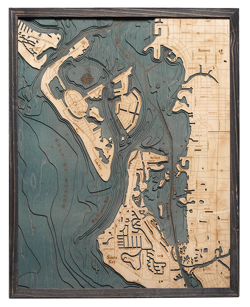 Siesta Key, Florida 3D layered wood map in laser-cut Baltic birch, shown framed against a light wall