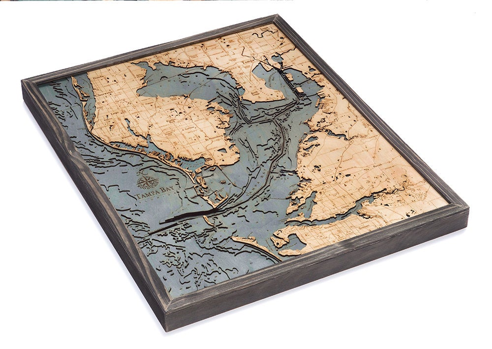 Tampa Bay, Florida 3D layered wood map in laser-cut Baltic birch, shown framed against a light wall
