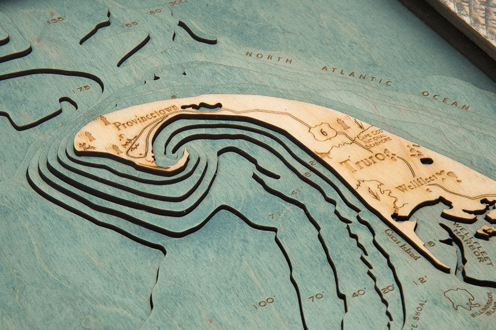 Cape Cod, Massachusetts 3D layered wood map in laser-cut Baltic birch, shown framed against a light wall