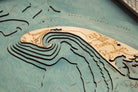 Cape Cod, Massachusetts 3D layered wood map in laser-cut Baltic birch, shown framed against a light wall