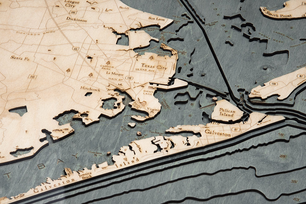 Houston, Texas 3D layered wood map in laser-cut Baltic birch, shown framed against a light wall
