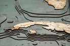 Gulf Of Mexico 3D layered wood map in laser-cut Baltic birch, shown framed against a light wall