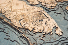 Charlotte Harbor, Florida 3D layered wood map in laser-cut Baltic birch, shown framed against a light wall