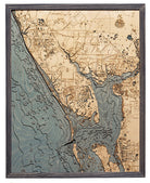 Charlotte Harbor, Florida 3D layered wood map in laser-cut Baltic birch, shown framed against a light wall