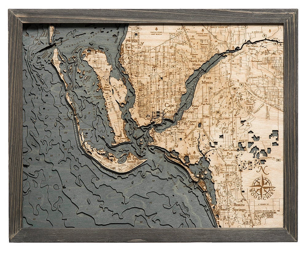 Fort Myers, Florida 3D layered wood map in laser-cut Baltic birch, shown framed against a light wall