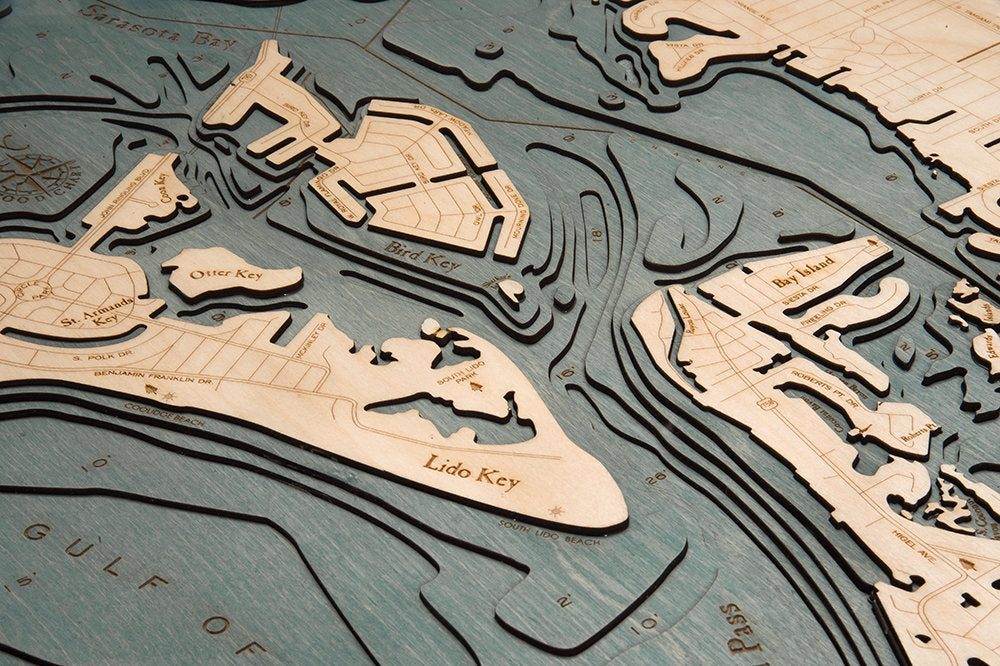 Siesta Key, Florida 3D layered wood map in laser-cut Baltic birch, shown framed against a light wall