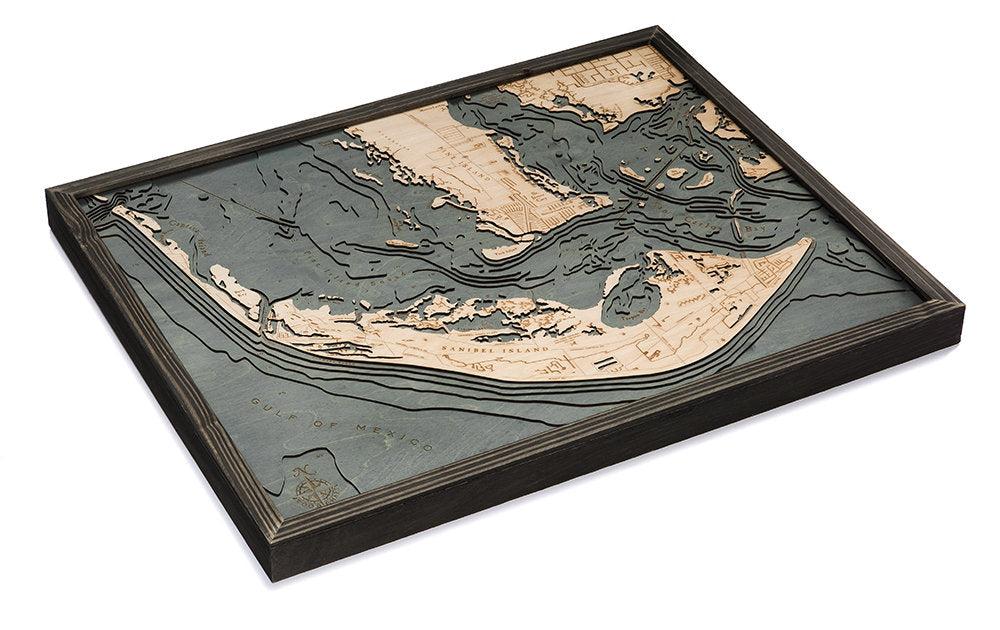 Sanibel Island, Florida 3D layered wood map in laser-cut Baltic birch, shown framed against a light wall