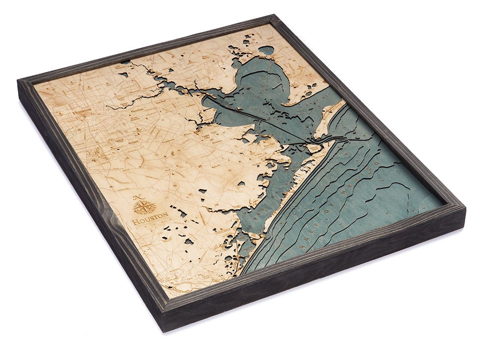 Houston, Texas 3D layered wood map in laser-cut Baltic birch, shown framed against a light wall