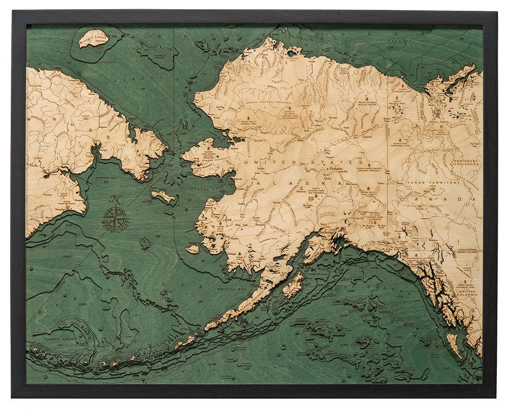 Alaska 3D layered wood map in laser-cut Baltic birch, shown framed against a light wall