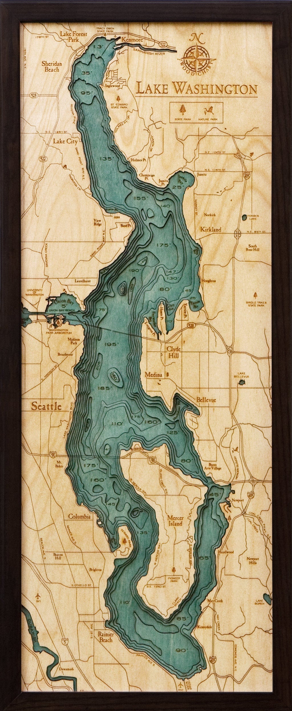 Lake Washington 3D layered wood map in laser-cut Baltic birch, shown framed against a light wall