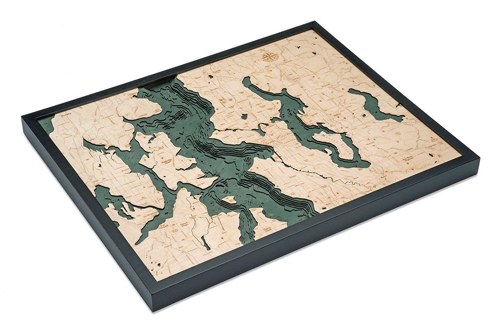 Seattle, Washington 3D layered wood map in laser-cut Baltic birch, shown framed against a light wall