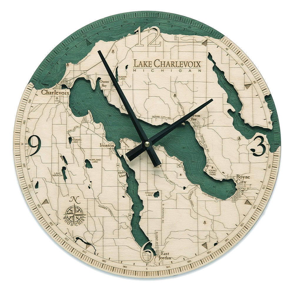 Lake Charlevoix, Michigan wood wall clock in laser-cut Baltic birch, shown framed against a light wall