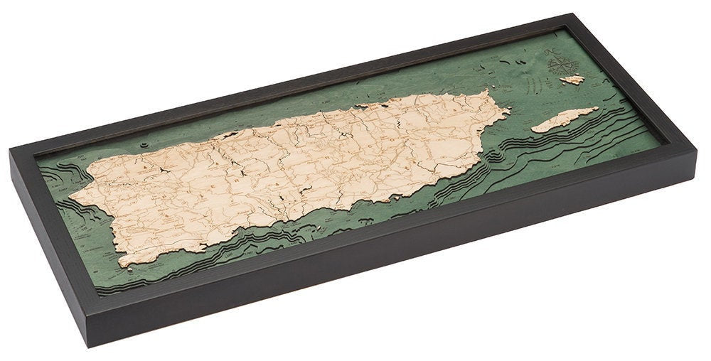 Puerto Rico 3D layered wood map in laser-cut Baltic birch, shown framed against a light wall