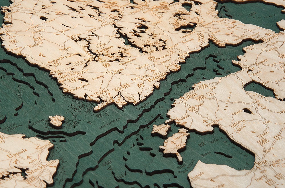 Scandinavia 3D layered wood map in laser-cut Baltic birch, shown framed against a light wall