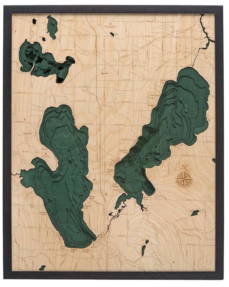 Burt & Mullet Lakes, Michigan 3D layered wood map in laser-cut Baltic birch, shown framed against a light wall