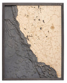 California Coast 3D layered wood map in laser-cut Baltic birch, shown framed against a light wall