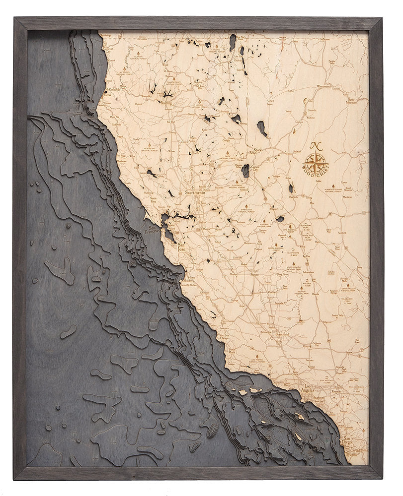California Coast 3D layered wood map in laser-cut Baltic birch, shown framed against a light wall