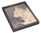 Carmel & Monterey, California 3D layered wood map in laser-cut Baltic birch, shown framed against a light wall