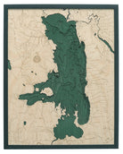 Flathead Lake, Montana 3D layered wood map in laser-cut Baltic birch, shown framed against a light wall