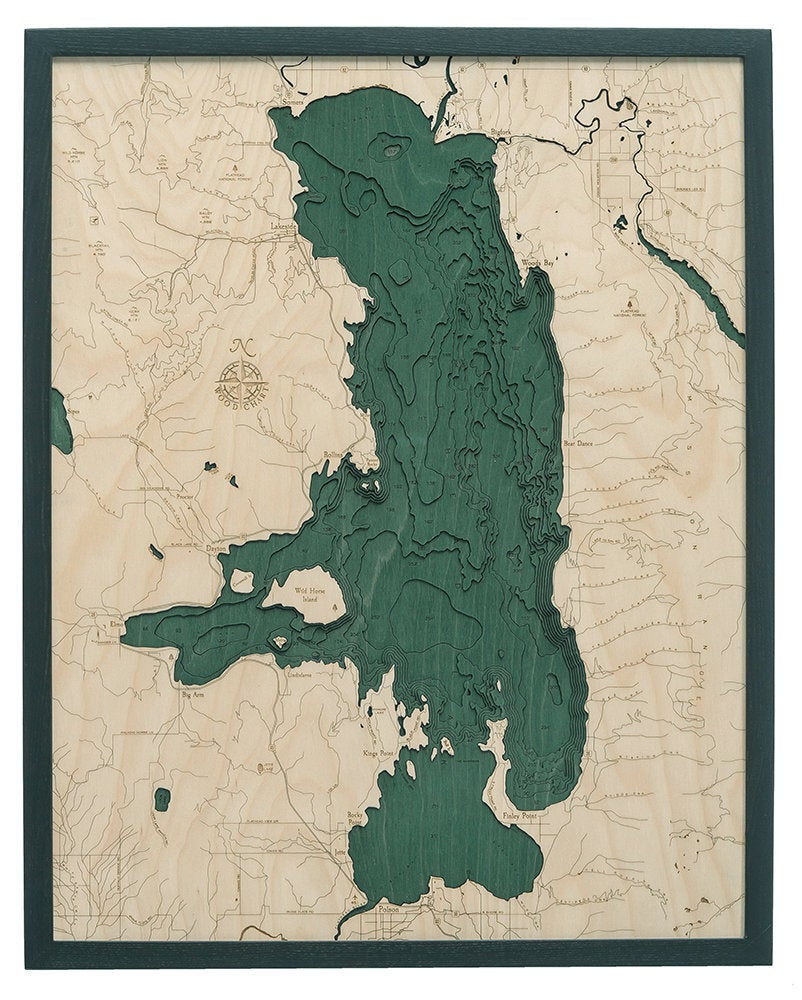 Flathead Lake, Montana 3D layered wood map in laser-cut Baltic birch, shown framed against a light wall