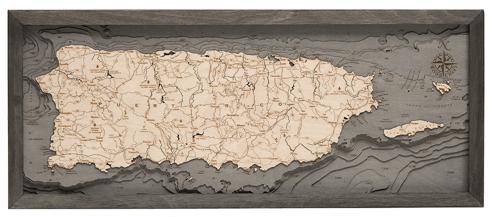 Puerto Rico 3D layered wood map in laser-cut Baltic birch, shown framed against a light wall